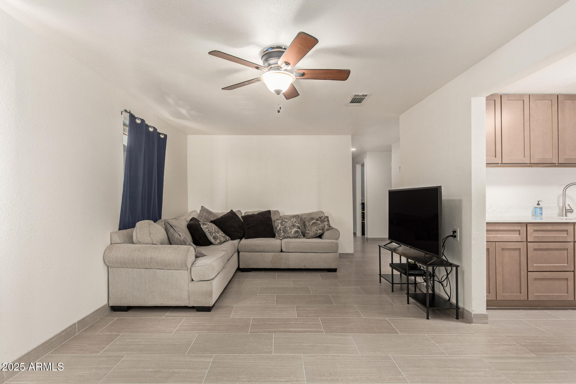 1221 East Alta Vista Road Phoenix, AZ 85042 - Photo 7 of 33 a living room with furniture and a flat screen tv