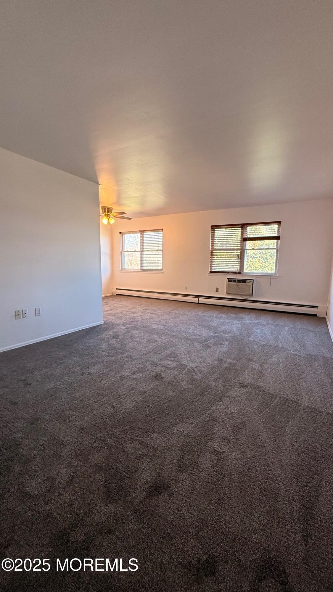 76 Manchester Court, Unit H Freehold, NJ 07728 - Photo 2 of 10 an empty room with windows