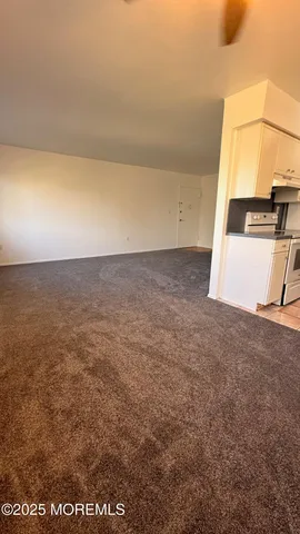 a kitchen with granite countertop a stove and a refrigerator