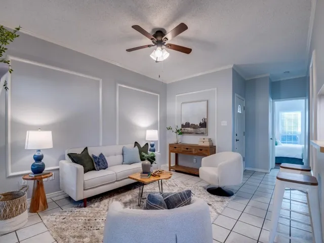 a living room with furniture and a chandelier