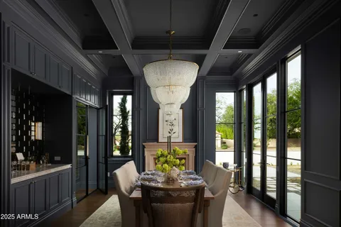 a dining room with furniture a chandelier and wooden floor