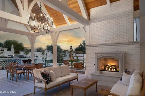 a living room with furniture a fireplace and a chandelier