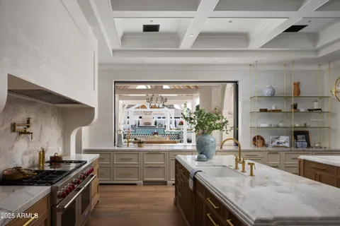 a kitchen with stainless steel appliances a sink stove and cabinets