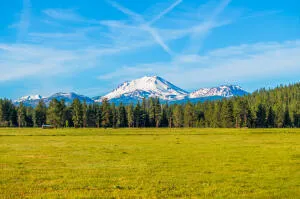 a view of swimming pool in front of house with outdoor seating