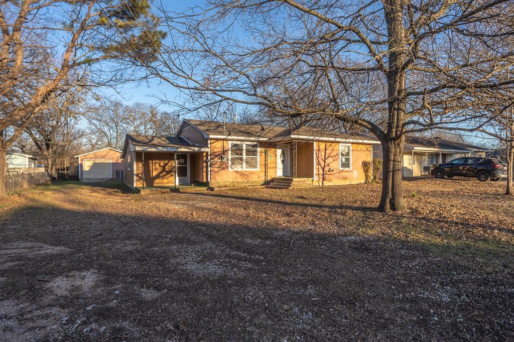 1414 Rice Avenue Gainesville, TX 76240 - Photo 2 of 21 a view of a building with large trees
