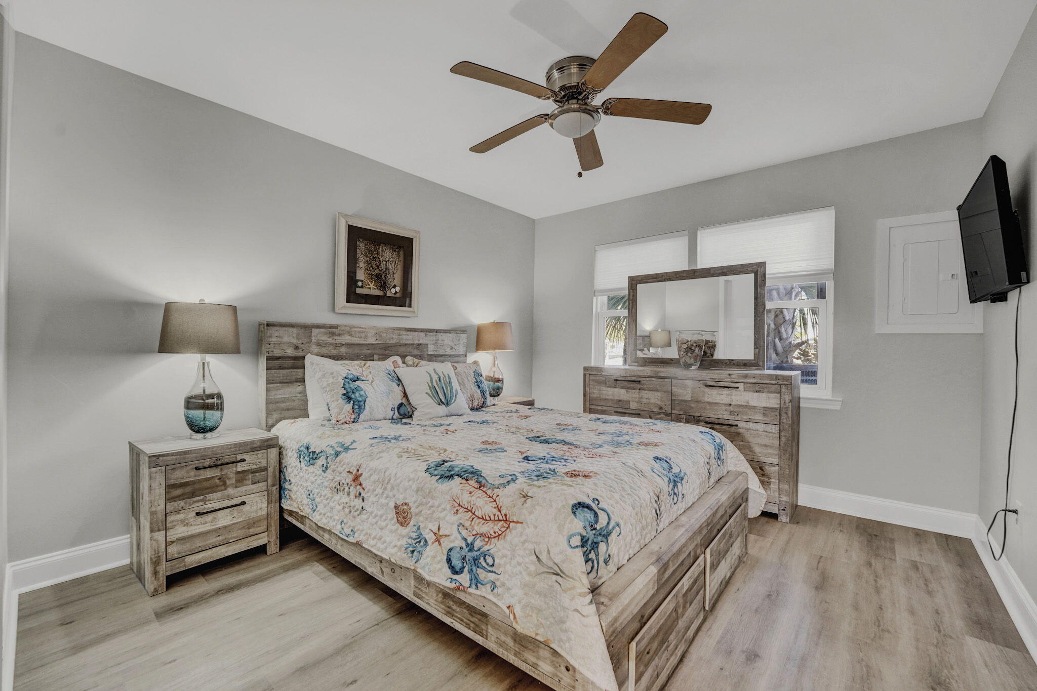 8046 East County Highway 30A Inlet Beach, FL 32461 - Photo 11 of 36 a bedroom with a bed a mirror and a flat tv screen on dresser