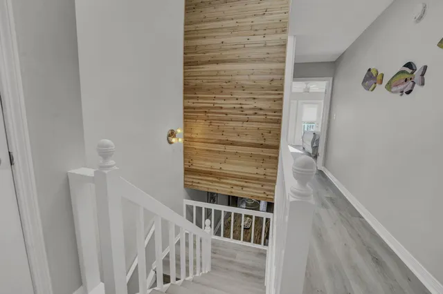 a view of staircase with wooden floor