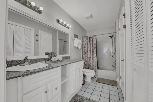 a bathroom with a granite countertop sink mirror and shower
