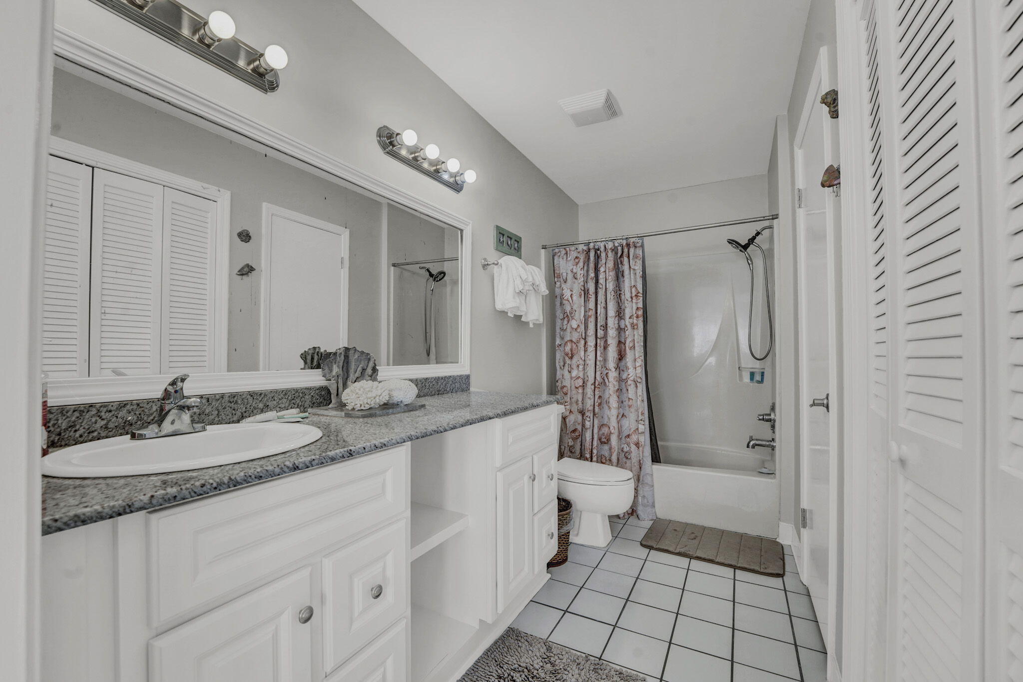 8046 East County Highway 30A Inlet Beach, FL 32461 - Photo 24 of 36 a bathroom with a granite countertop sink mirror and shower