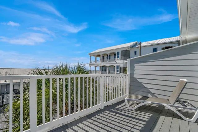 a view of a balcony with wooden floor and fence