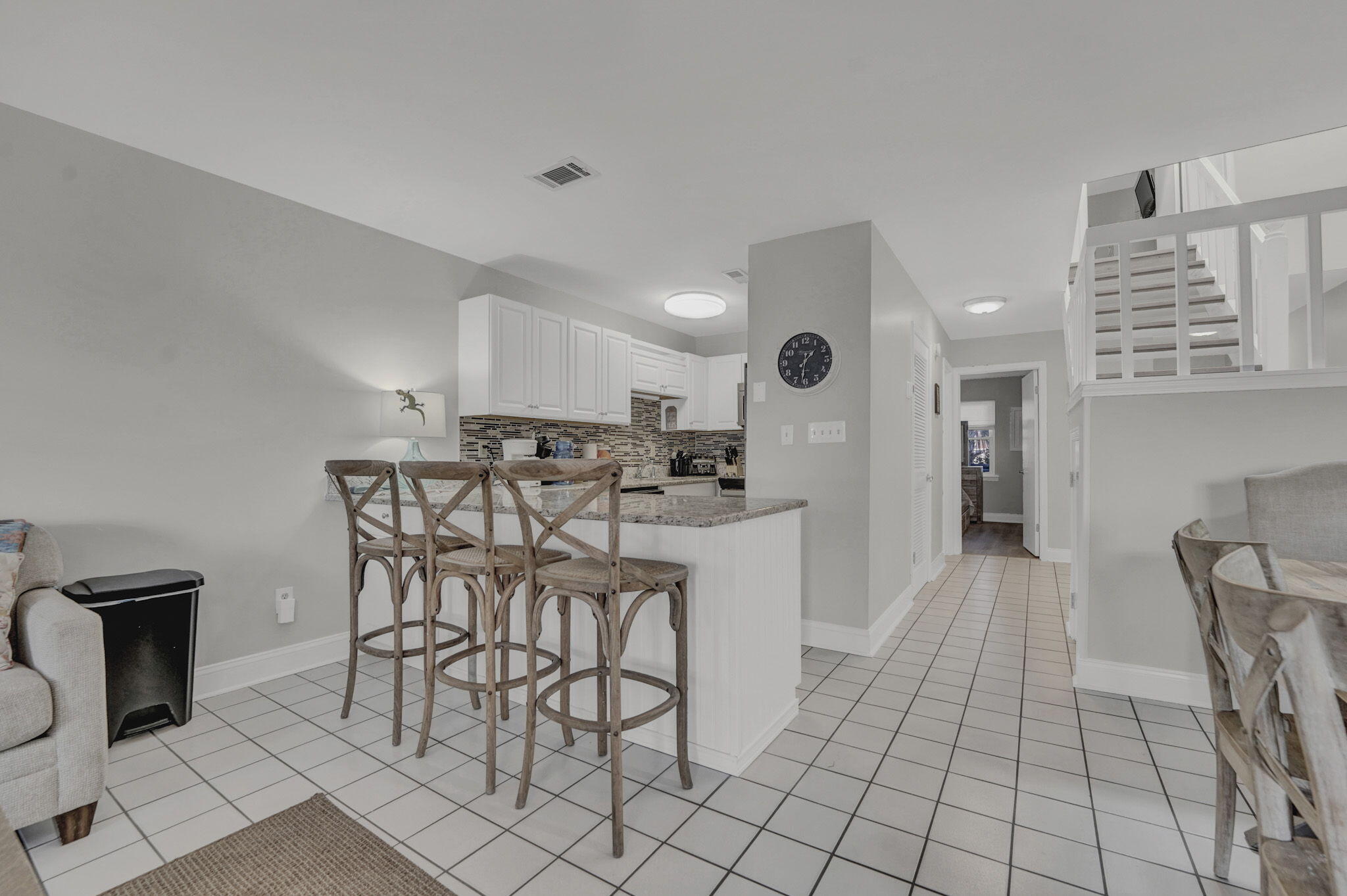 8046 East County Highway 30A Inlet Beach, FL 32461 - Photo 5 of 36 a kitchen with stainless steel appliances kitchen island granite countertop a table and chairs in it