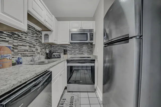 a kitchen with a refrigerator and a sink