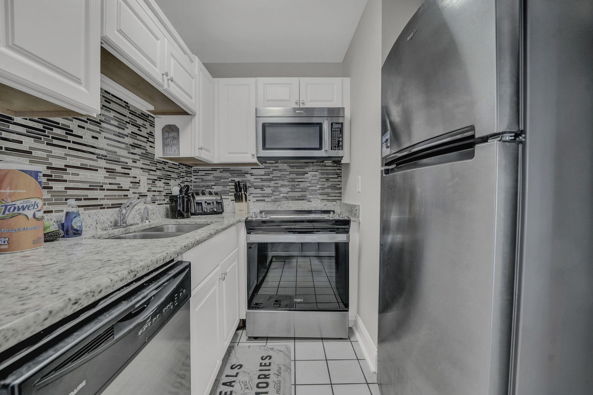 8046 East County Highway 30A Inlet Beach, FL 32461 - Photo 9 of 36 a kitchen with a refrigerator and a sink