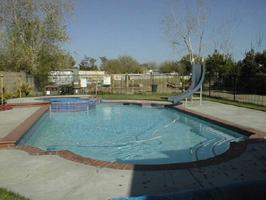 40704 Fieldspring Street Lancaster, CA 93535 - Photo 2 of 2 a view of a swimming pool with an outdoor space and seating area