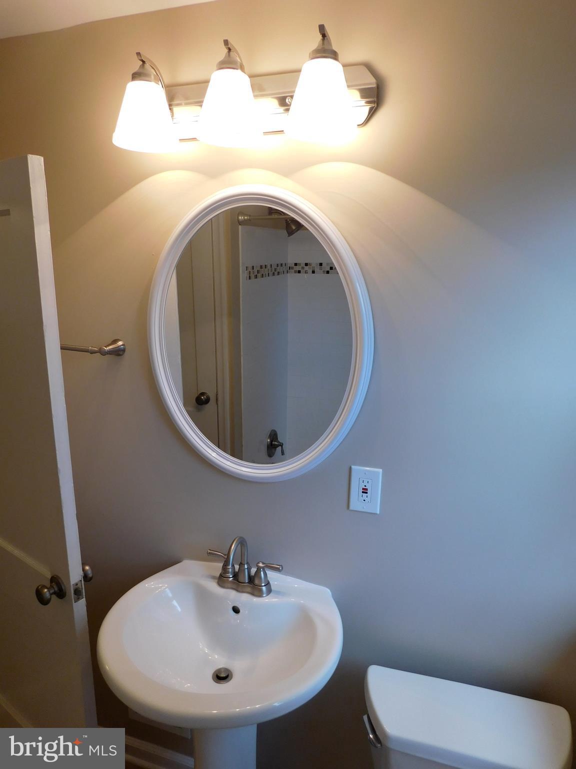 2012 Winford Road Baltimore, MD 21239 - Photo 22 of 30 a bathroom with a sink and mirror
