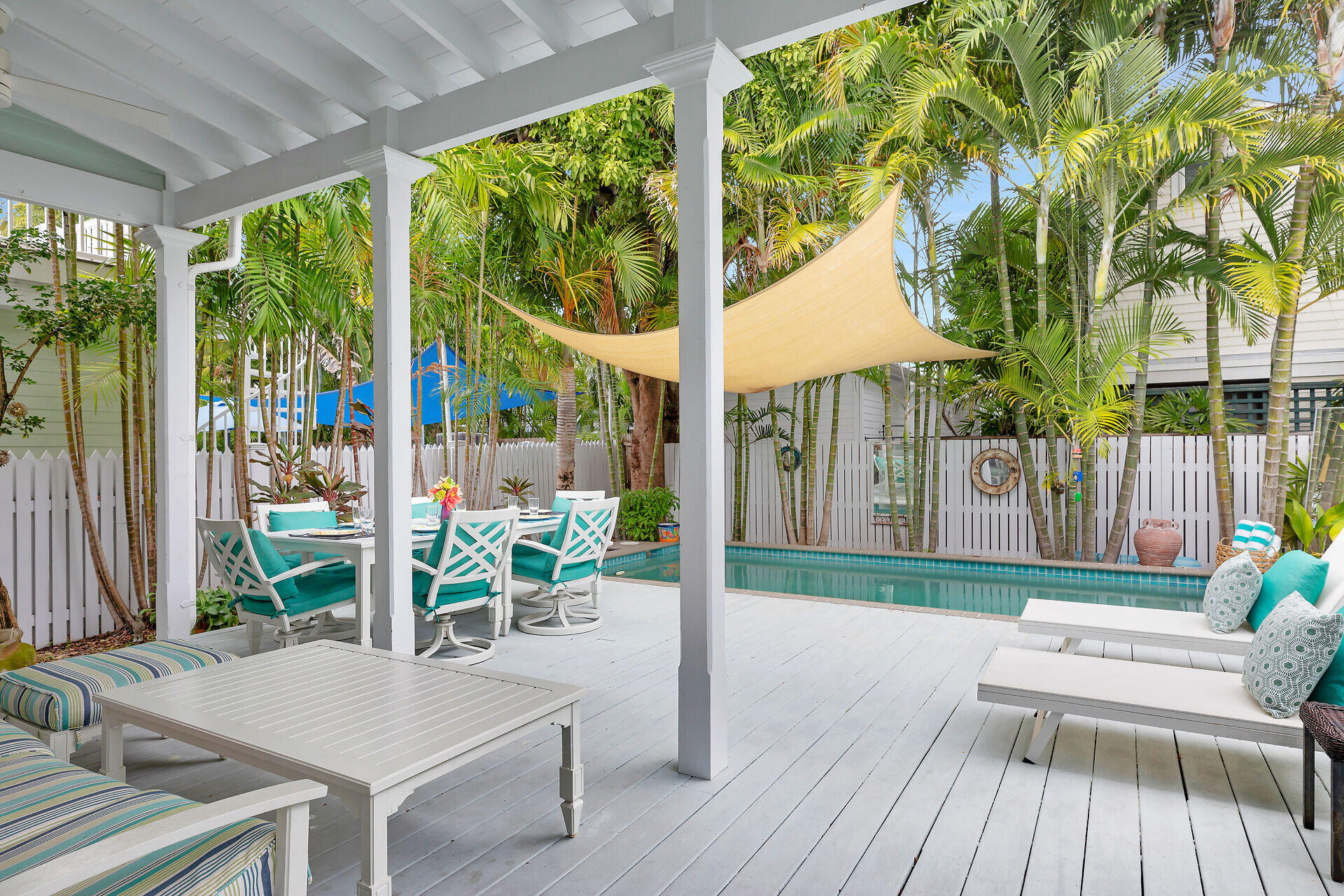 1309 Petronia Street Key West, FL 33040 - Photo 20 of 38 a view of a patio with table and chairs potted plants and floor to ceiling window