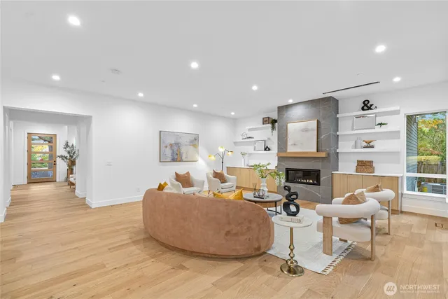 a living room with furniture a fireplace and a table