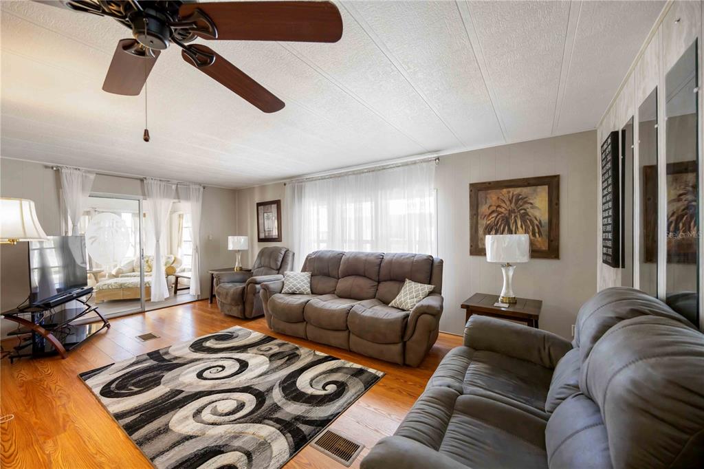 10303 Burnt Store Road, Unit 169 Punta Gorda, FL 33950 - Photo 11 of 34 a living room with furniture a flat screen tv and a window