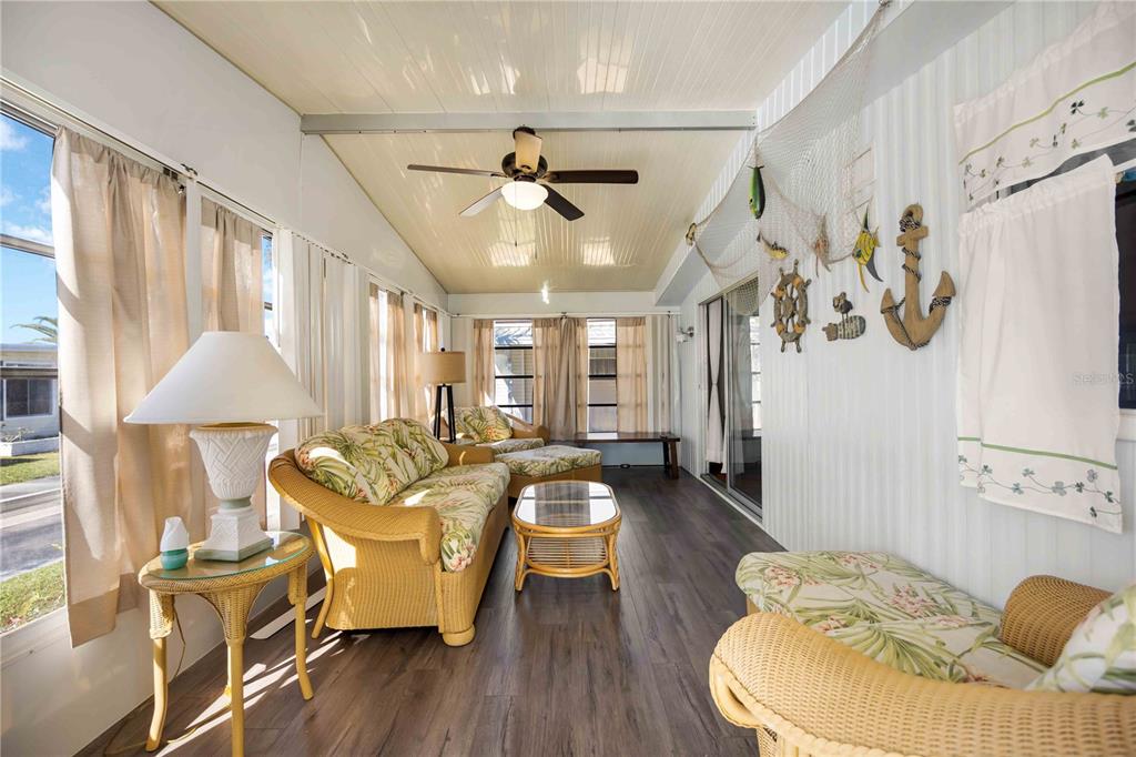 10303 Burnt Store Road, Unit 169 Punta Gorda, FL 33950 - Photo 12 of 34 a living room with furniture and a chandelier