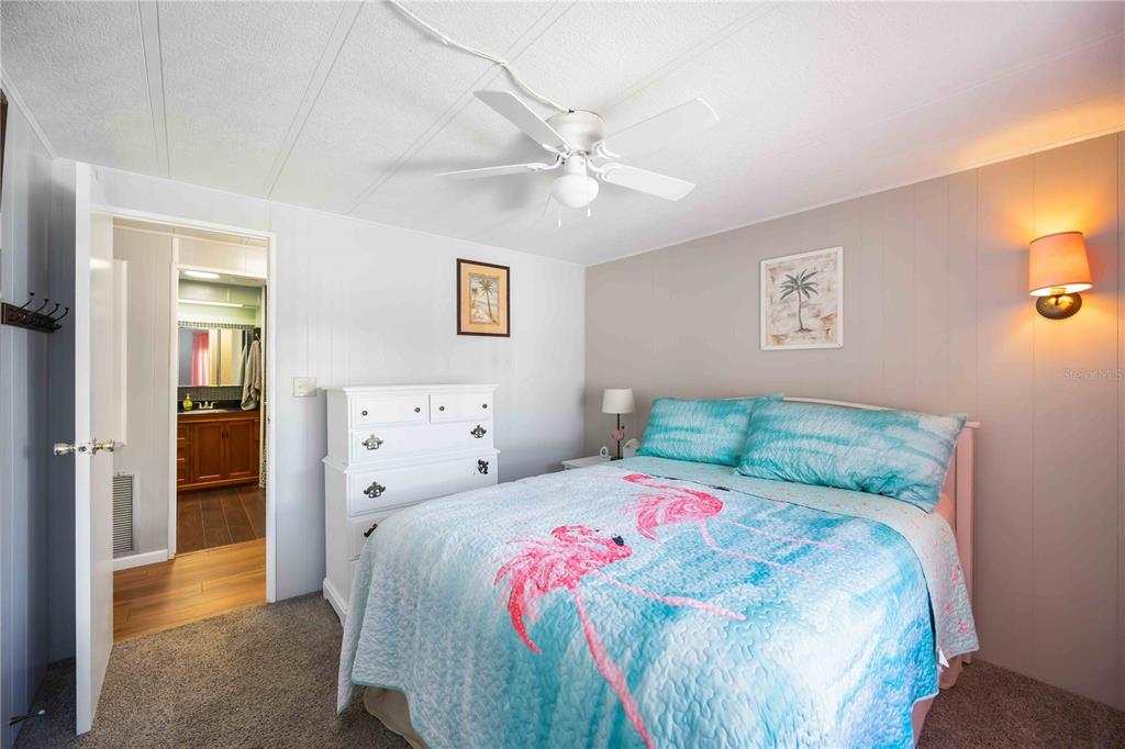 10303 Burnt Store Road, Unit 169 Punta Gorda, FL 33950 - Photo 15 of 34 a bedroom with a bed and a painting on the wall