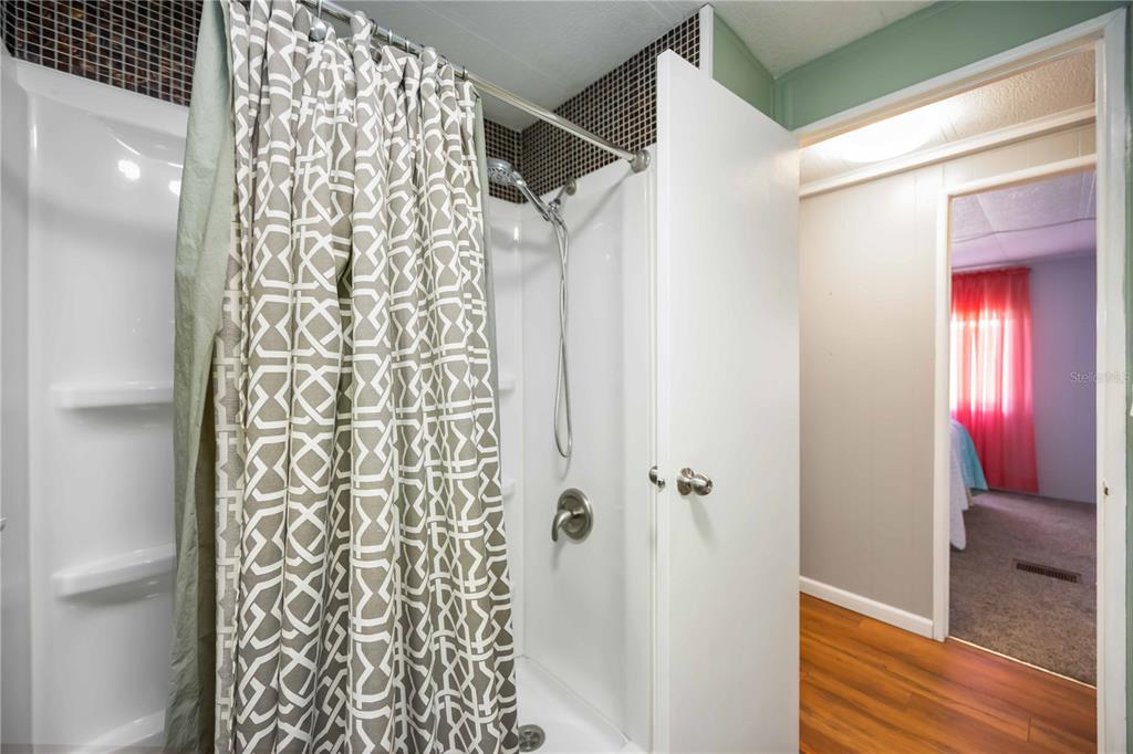 10303 Burnt Store Road, Unit 169 Punta Gorda, FL 33950 - Photo 16 of 34 a bathroom with a shower curtain and a sink