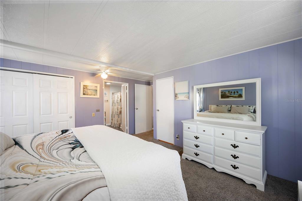 10303 Burnt Store Road, Unit 169 Punta Gorda, FL 33950 - Photo 19 of 34 a bedroom with a bed and a dresser