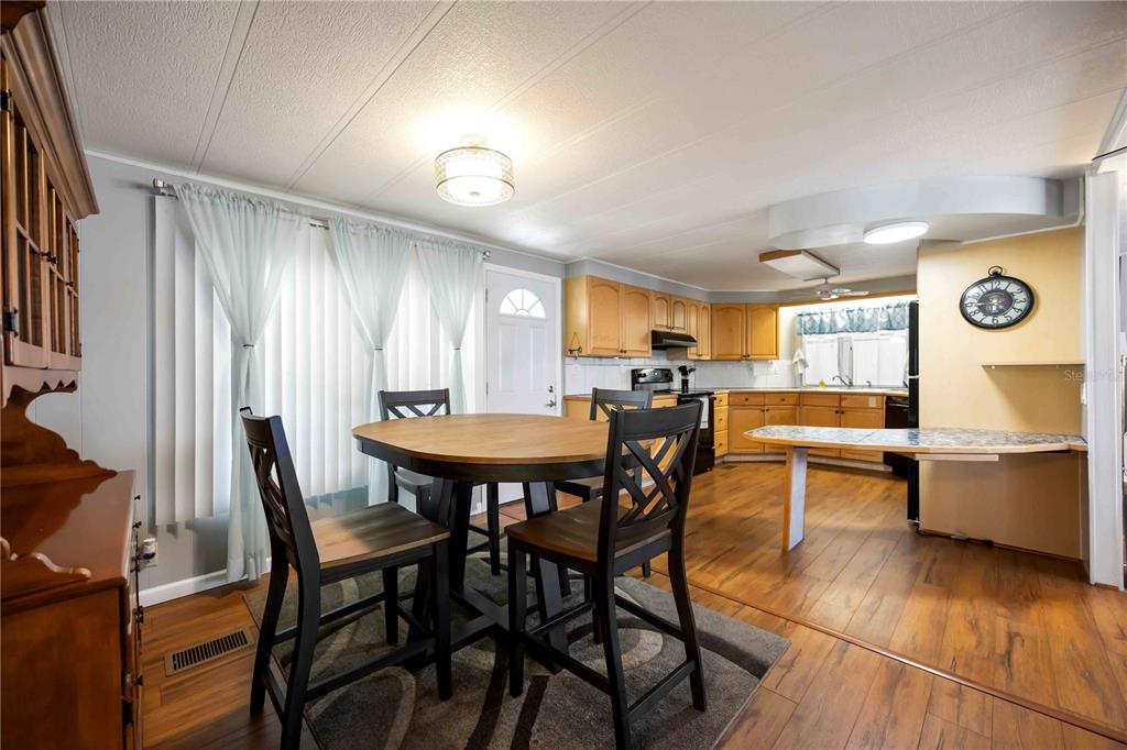 10303 Burnt Store Road, Unit 169 Punta Gorda, FL 33950 - Photo 7 of 34 a view of a dining room with furniture and window