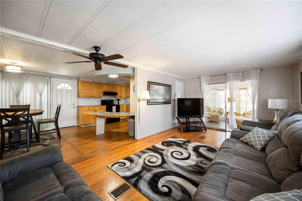 10303 Burnt Store Road, Unit 169 Punta Gorda, FL 33950 - Photo 9 of 34 a living room with furniture and a flat screen tv