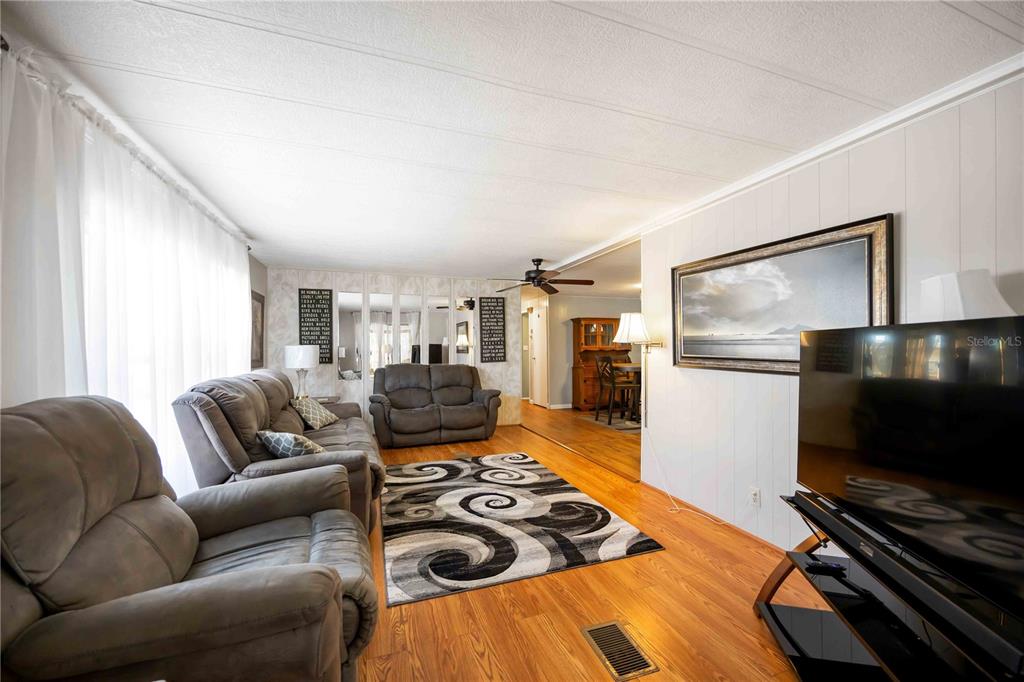 10303 Burnt Store Road, Unit 169 Punta Gorda, FL 33950 - Photo 10 of 34 a living room with furniture and a flat screen tv