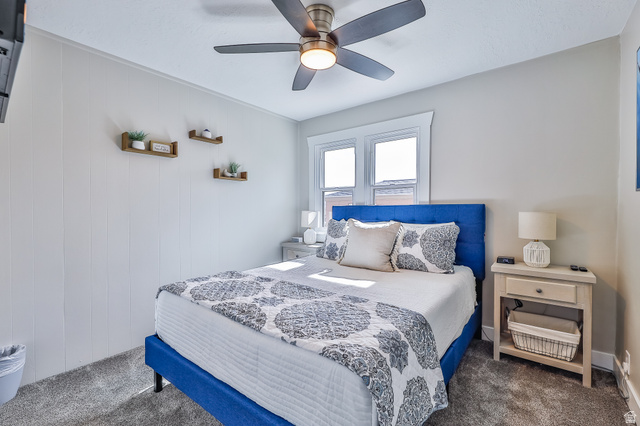 59 East 8680th Street South Sandy, UT 84070 - Photo 9 of 33 Bright interior space featuring a window with white trim, a ceiling fan with integrated lighting, and light-colored wall paneling