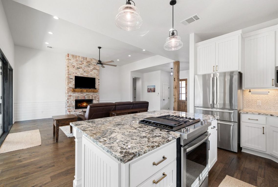 340 Mark Young Road Smithville, TX 78957 - Photo 15 of 40 a kitchen with stainless steel appliances granite countertop a sink stove and refrigerator