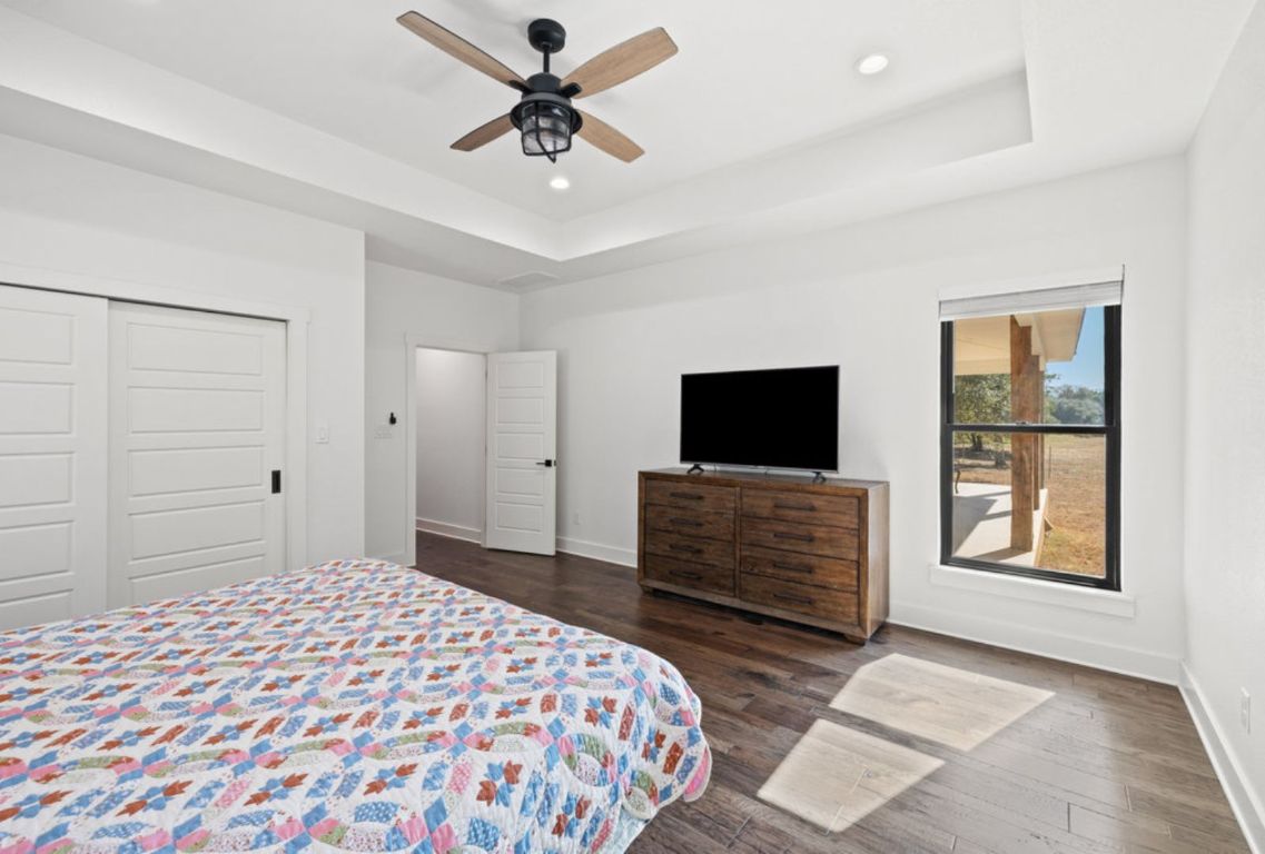 340 Mark Young Road Smithville, TX 78957 - Photo 18 of 40 a bedroom with a bed and a flat screen tv