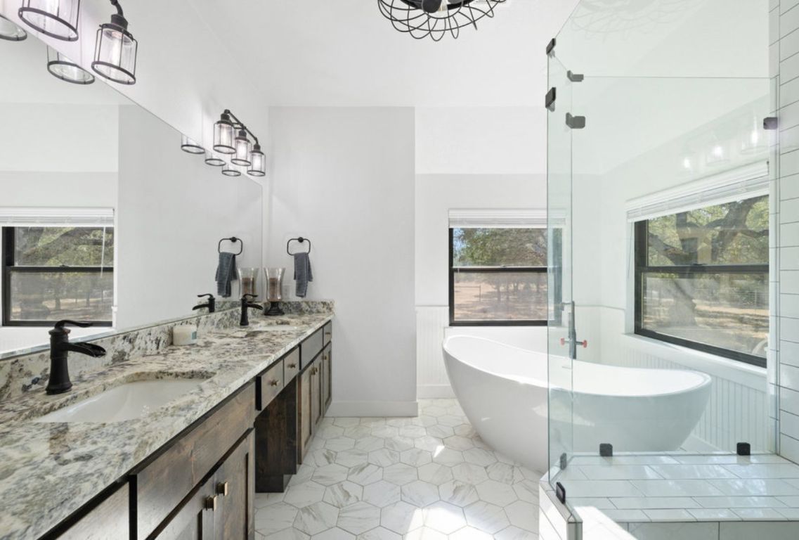 340 Mark Young Road Smithville, TX 78957 - Photo 20 of 40 a bathroom with a granite countertop sink and a bathtub