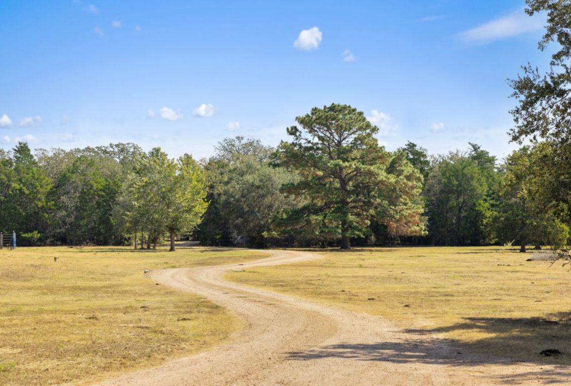 340 Mark Young Road Smithville, TX 78957 - Photo 2 of 40 a swimming pool is in the middle of a yard
