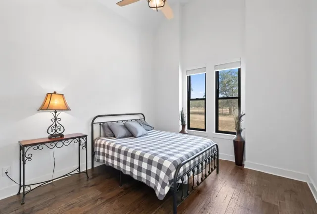 a bedroom with a bed and dresser with mirror
