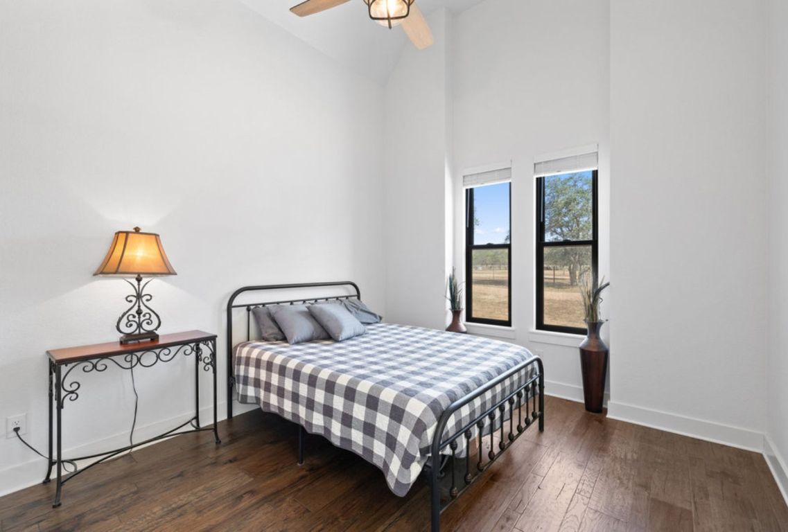 340 Mark Young Road Smithville, TX 78957 - Photo 24 of 40 a bedroom with a bed and dresser with mirror
