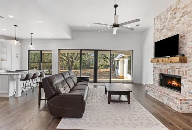 a living room with furniture fireplace and flat screen tv