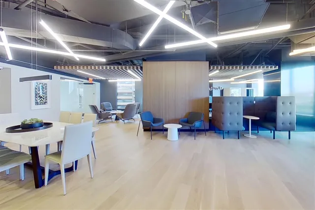 a living room with furniture and kitchen area