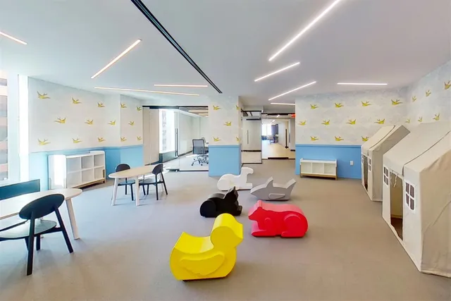 a living room with furniture and kitchen space