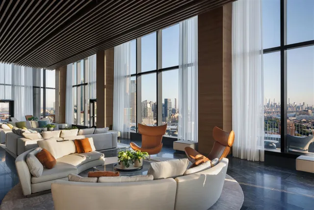 a living room with furniture and large windows