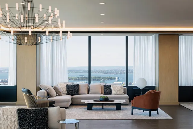 a living room with furniture and a floor to ceiling window