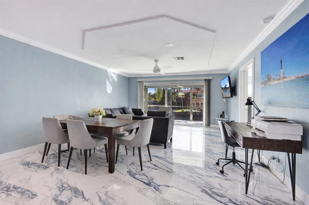 2330 Northeast 36th Street, Unit 9 Lighthouse Point, FL 33064 - Photo 19 of 48 a dining room with furniture a rug and wooden floor