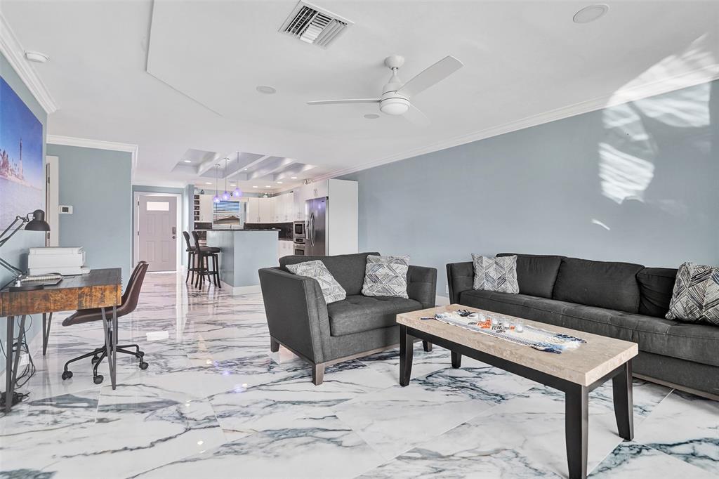 2330 Northeast 36th Street, Unit 9 Lighthouse Point, FL 33064 - Photo 20 of 48 a living room with furniture and a dining table with kitchen view