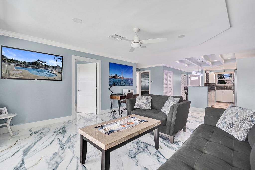 2330 Northeast 36th Street, Unit 9 Lighthouse Point, FL 33064 - Photo 21 of 48 a living room with furniture and kitchen view