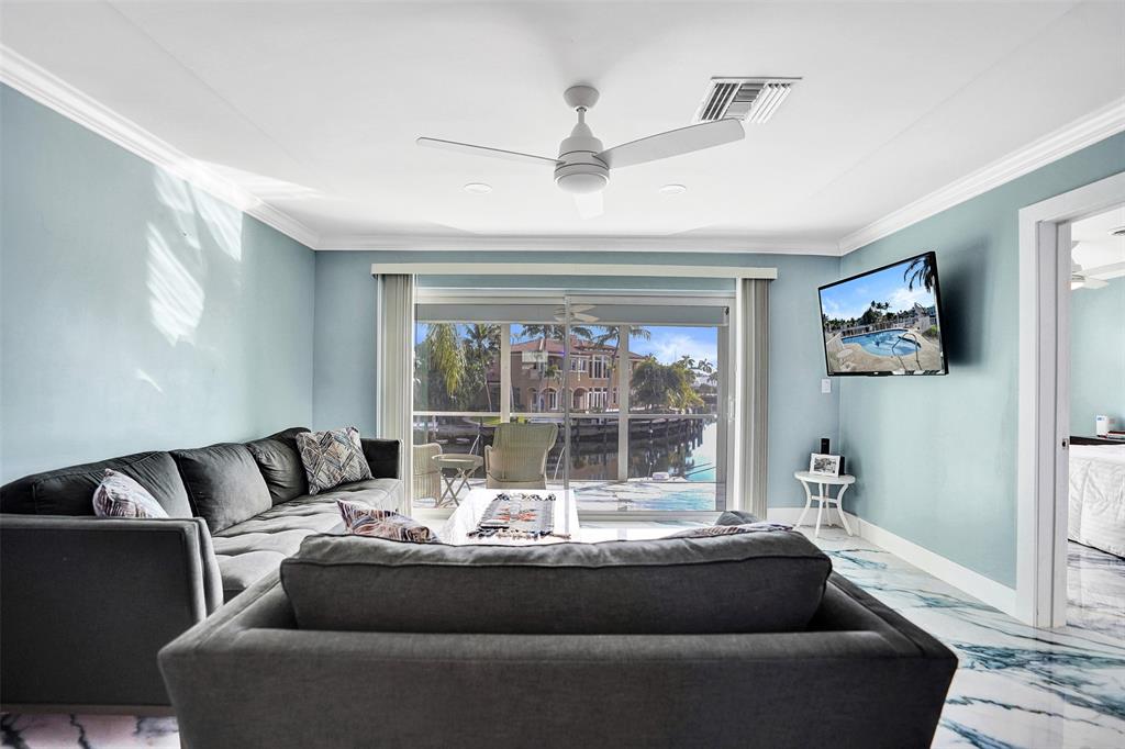 2330 Northeast 36th Street, Unit 9 Lighthouse Point, FL 33064 - Photo 23 of 48 a living room with furniture and a large window
