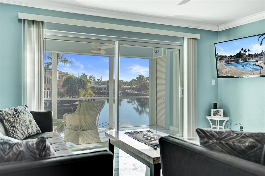 2330 Northeast 36th Street, Unit 9 Lighthouse Point, FL 33064 - Photo 24 of 48 a living room with furniture and a window