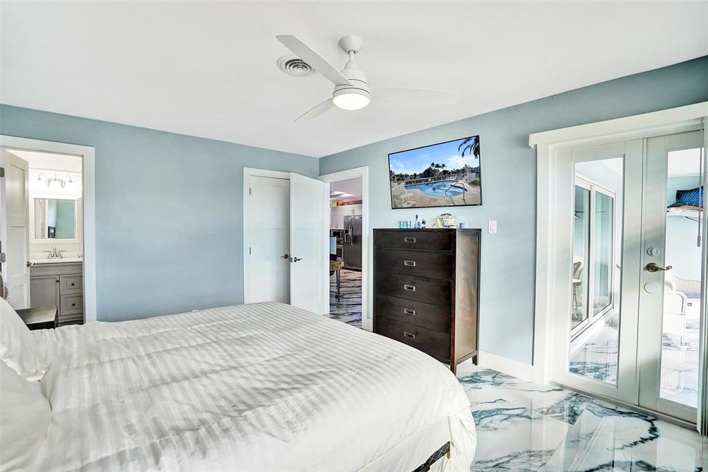 2330 Northeast 36th Street, Unit 9 Lighthouse Point, FL 33064 - Photo 28 of 48 a bedroom with a bed and a dresser