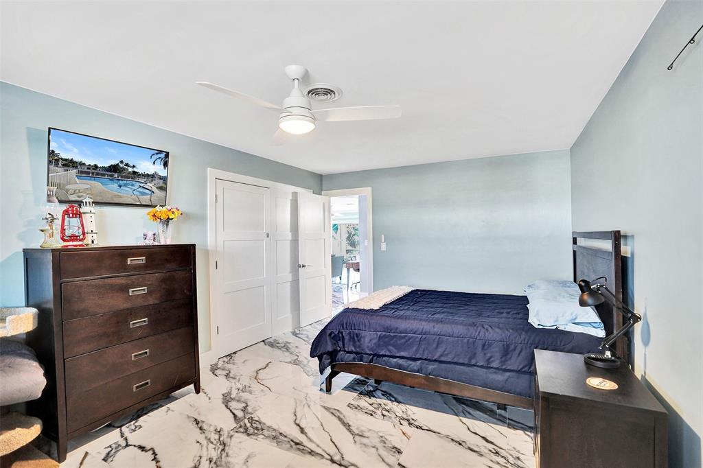 2330 Northeast 36th Street, Unit 9 Lighthouse Point, FL 33064 - Photo 36 of 48 a bedroom with a bed and a dresser