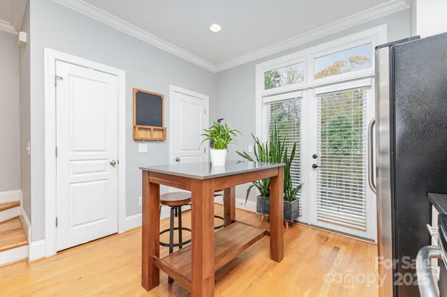 a dining room with furniture and wooden floor