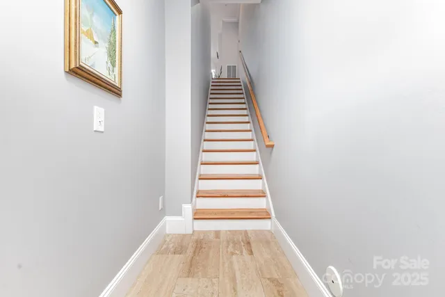 a view of a hallway with stairs